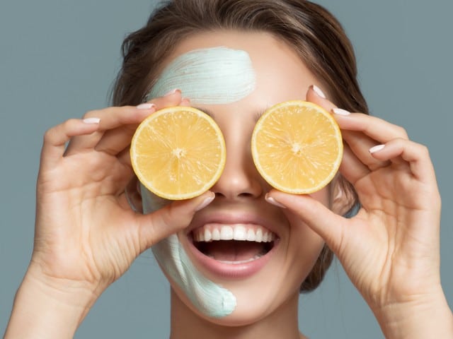 Portrait of beautiful woman with blue cream mask on her face.