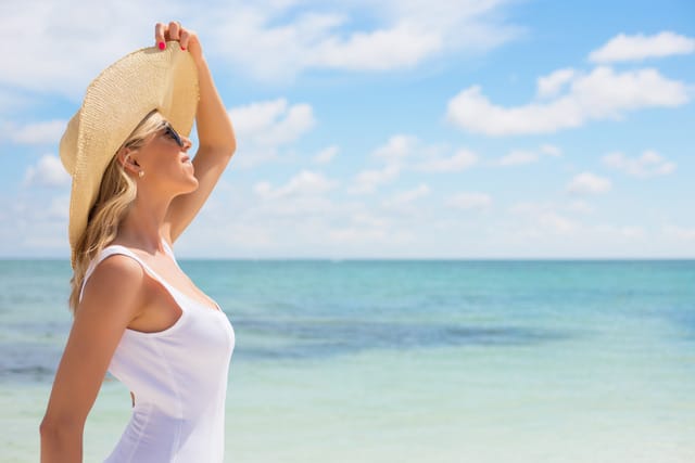 Woman in Plantation looks up at the sun as she wonders about how to get more vitamin D